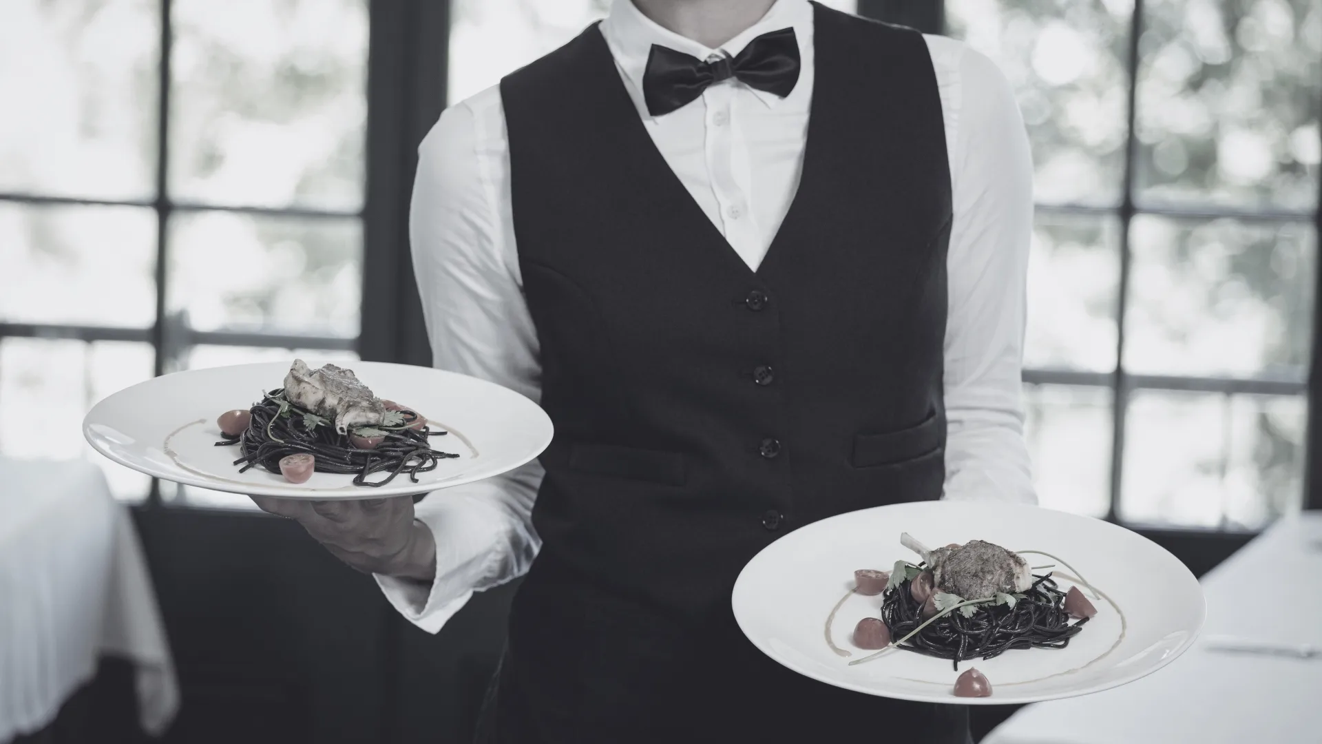 Waiter presenting fine dining dishes